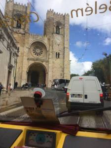 tuktuk passing by lisbon cathedral